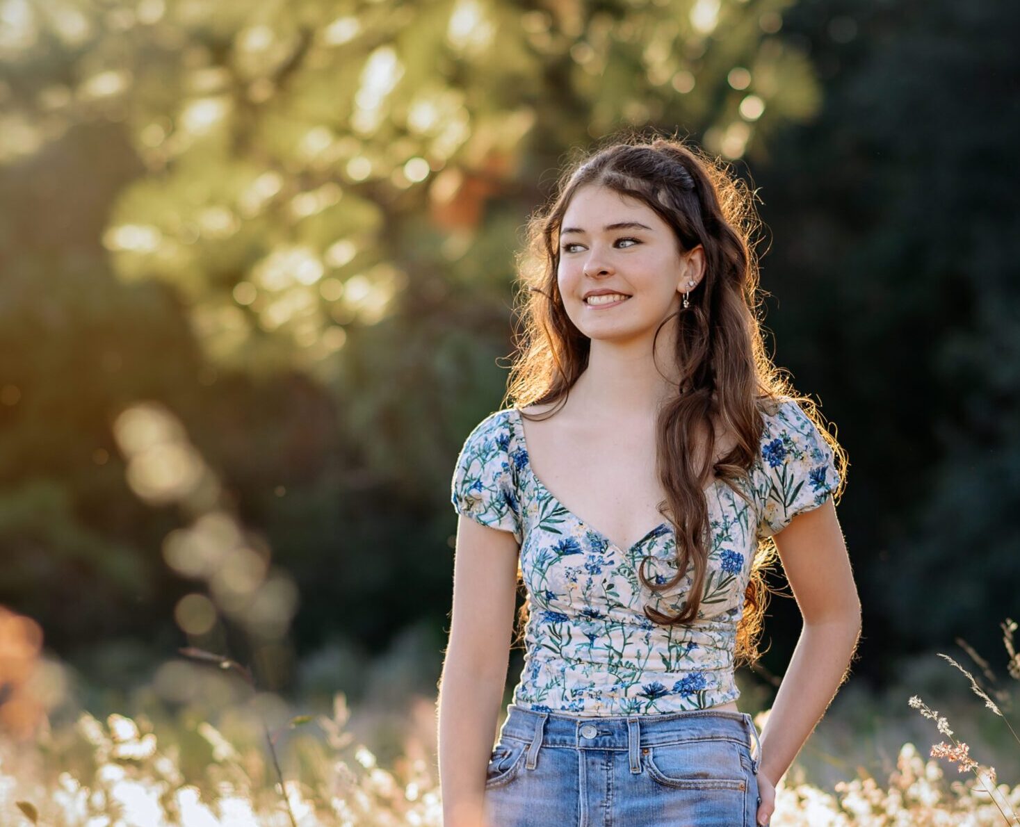 Orlando Senior Picture of a girl in a field with tall grass.