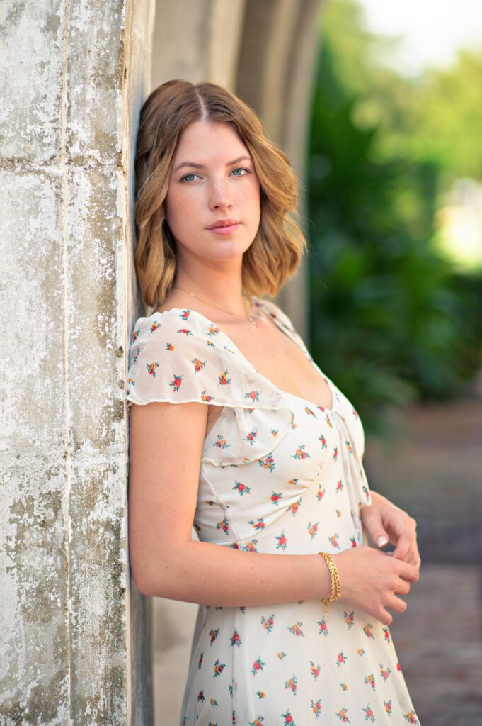 Beautiful blonde senior with flowery dress on at Casa Feliz in Winter Park for her senior pictures. 