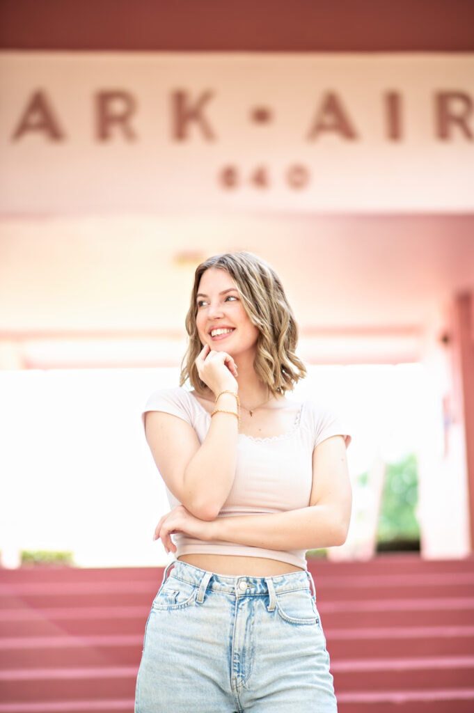 Beautiful blonde senior with flowery dress on at Casa Feliz in Winter Park for her senior pictures. 