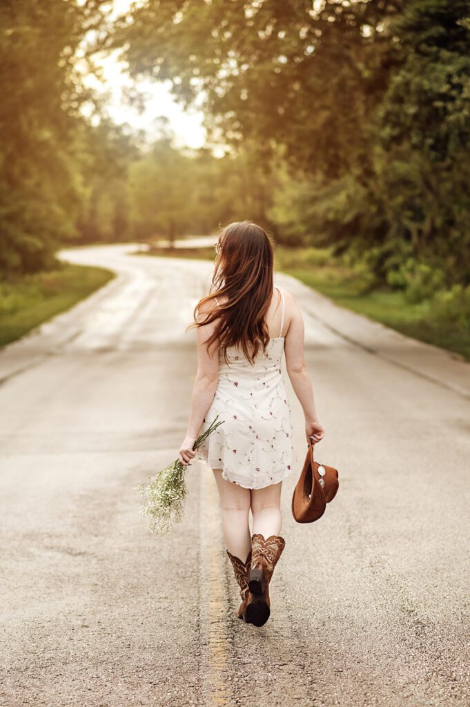Stylish senior girl in Orlando looking off into distance during golden hour shoot