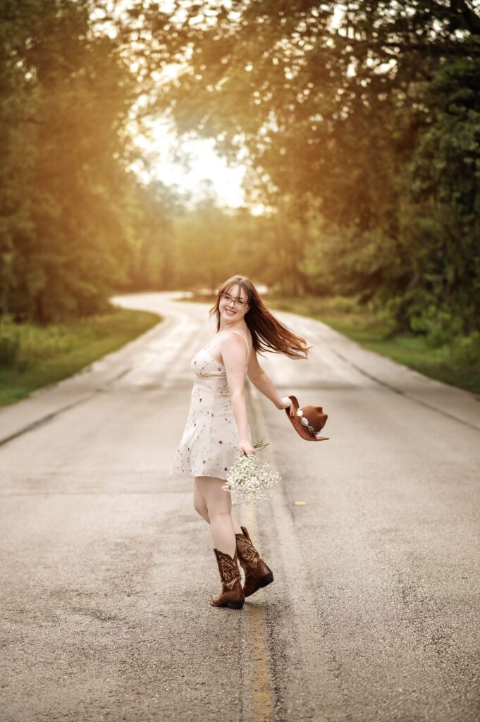 Addison smiling in natural light during western-themed Orlando Senior Photo Shoot