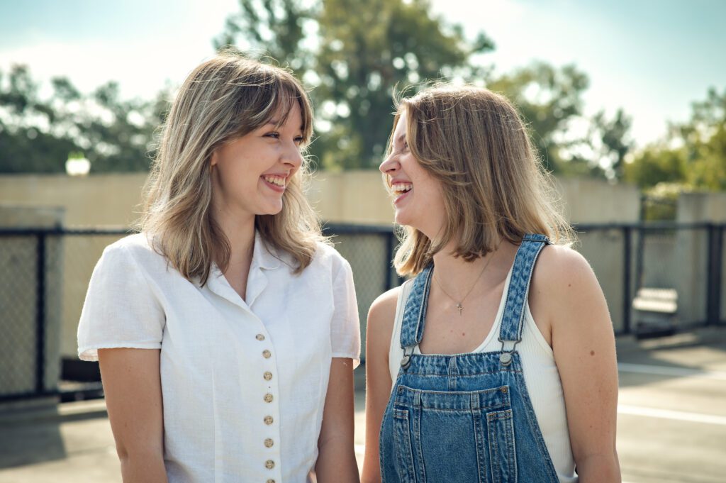 Genuine laughter moment between two seniors mid-walk during their fun best friend photo session
