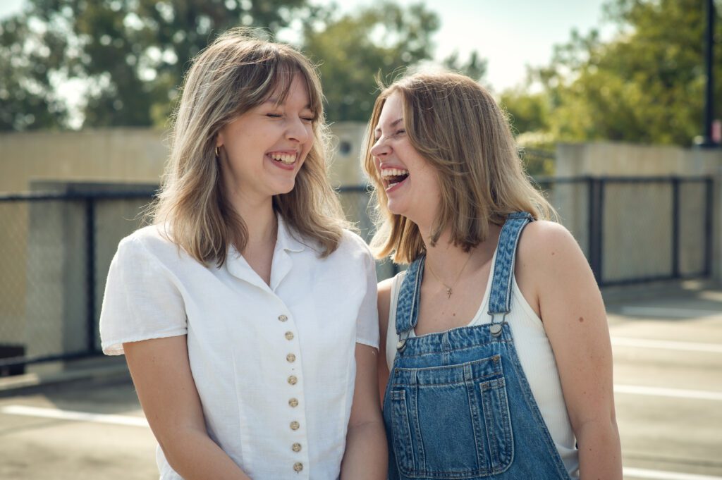 Genuine laughter moment between two seniors mid-walk during their fun best friend photo session