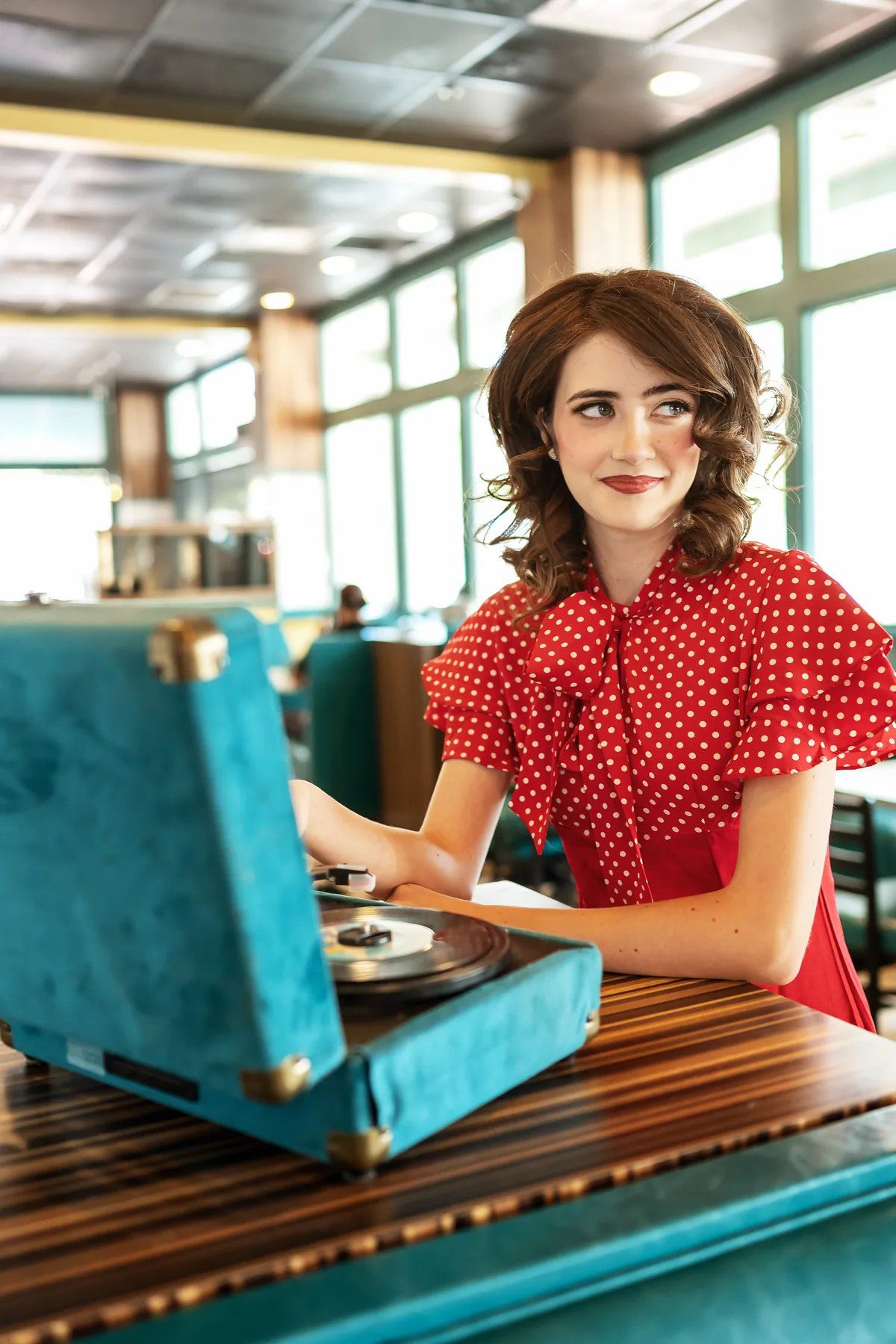 1950s-inspired senior portrait with a vintage record player