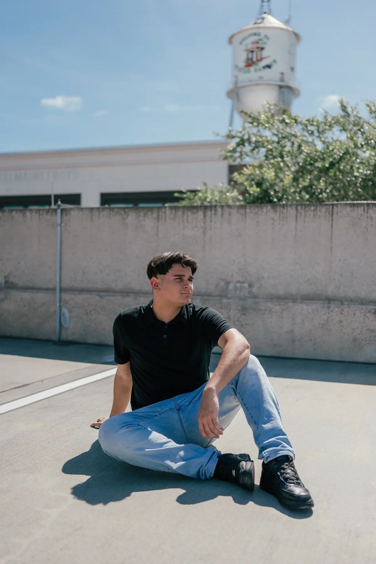 Downtown Winter Garden rooftop senior picture with the water tower in the background