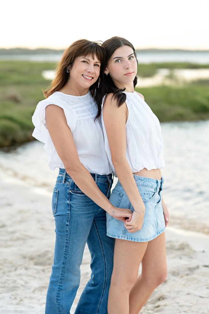 Mother and daughter standing together on the beach during a senior photo session