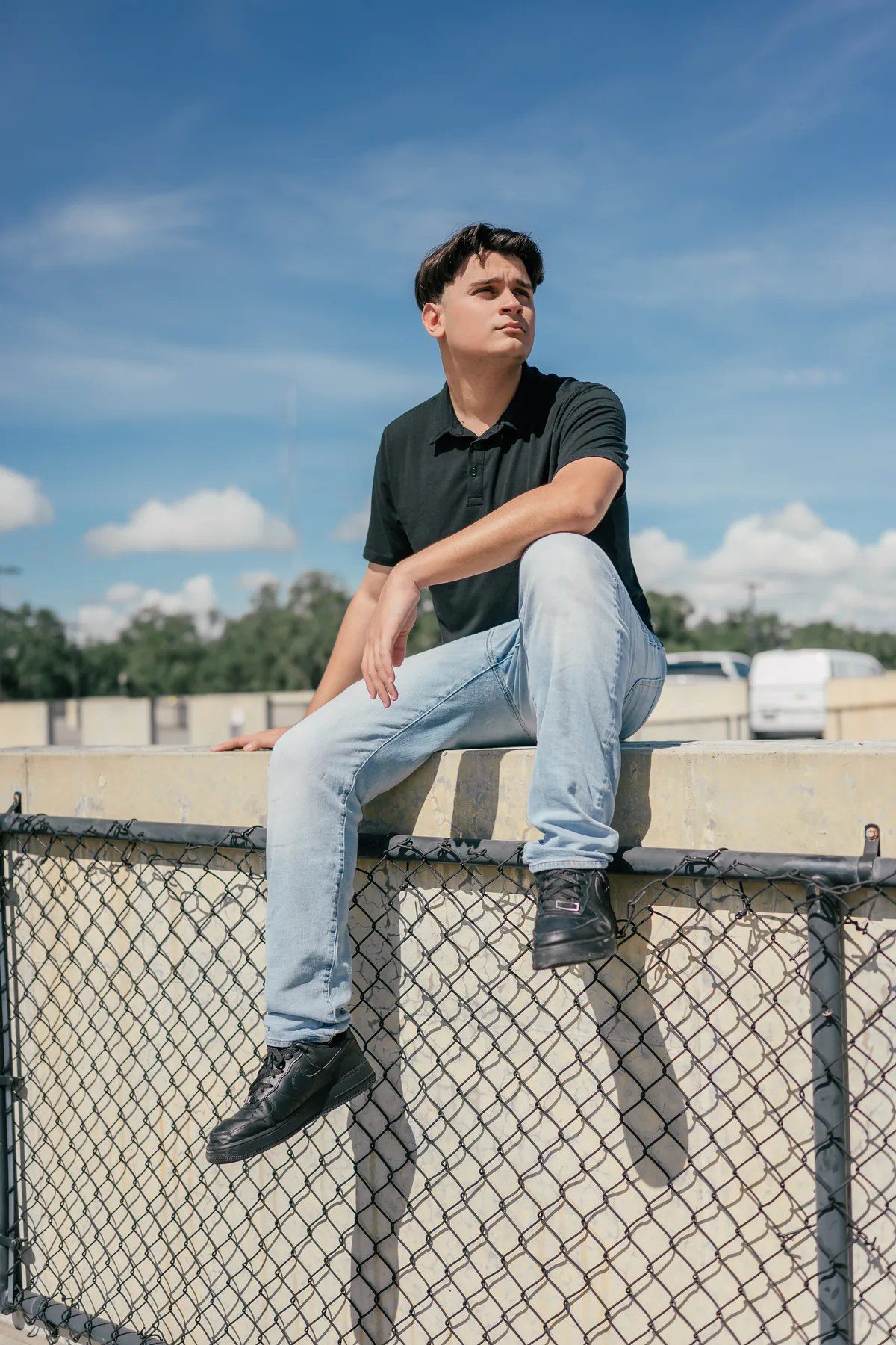 Winter Garden rooftop senior picture seated against the open sky