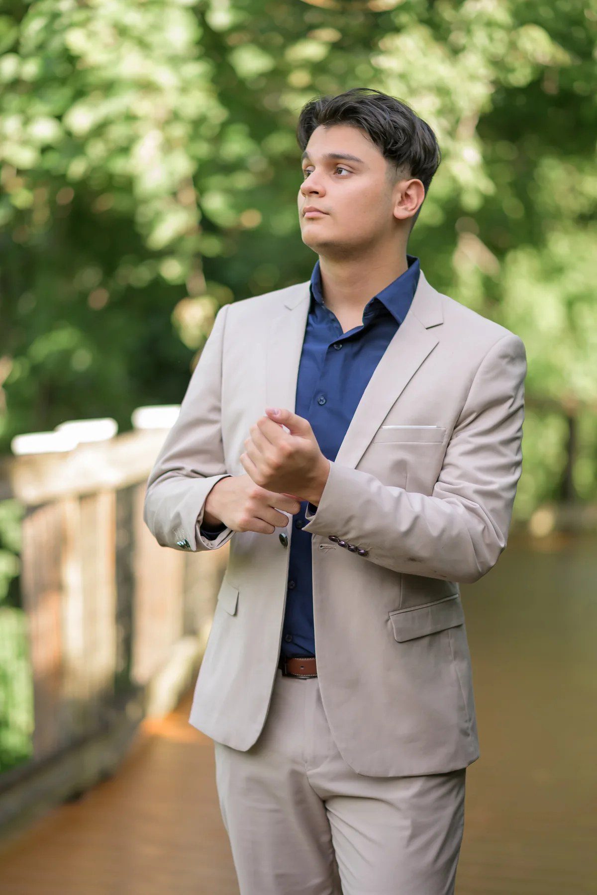 Tan suit senior picture on the Oakland Nature Preserve boardwalk