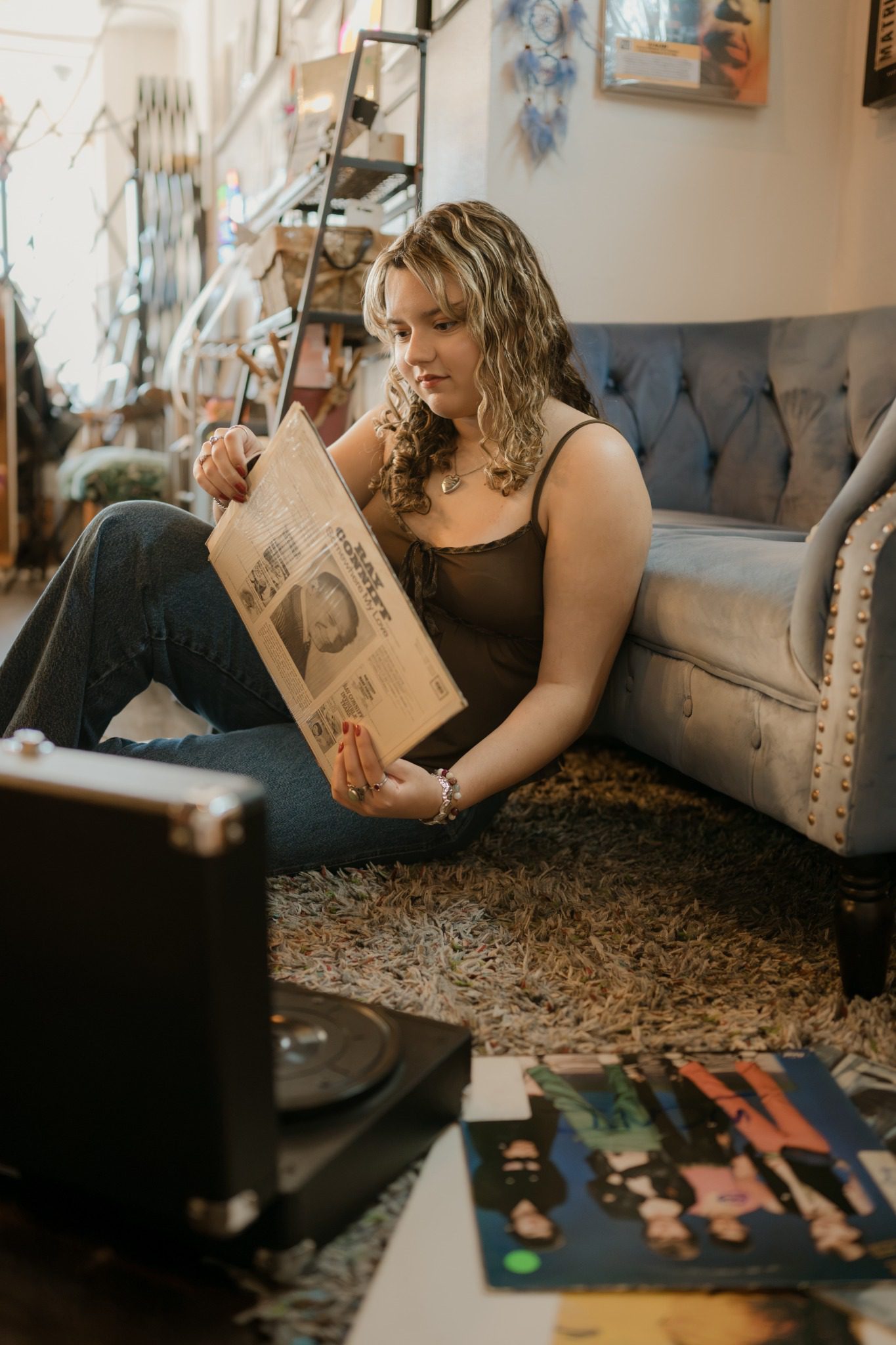 Senior looking through vinyl albums during creative senior pictures near Orlando
