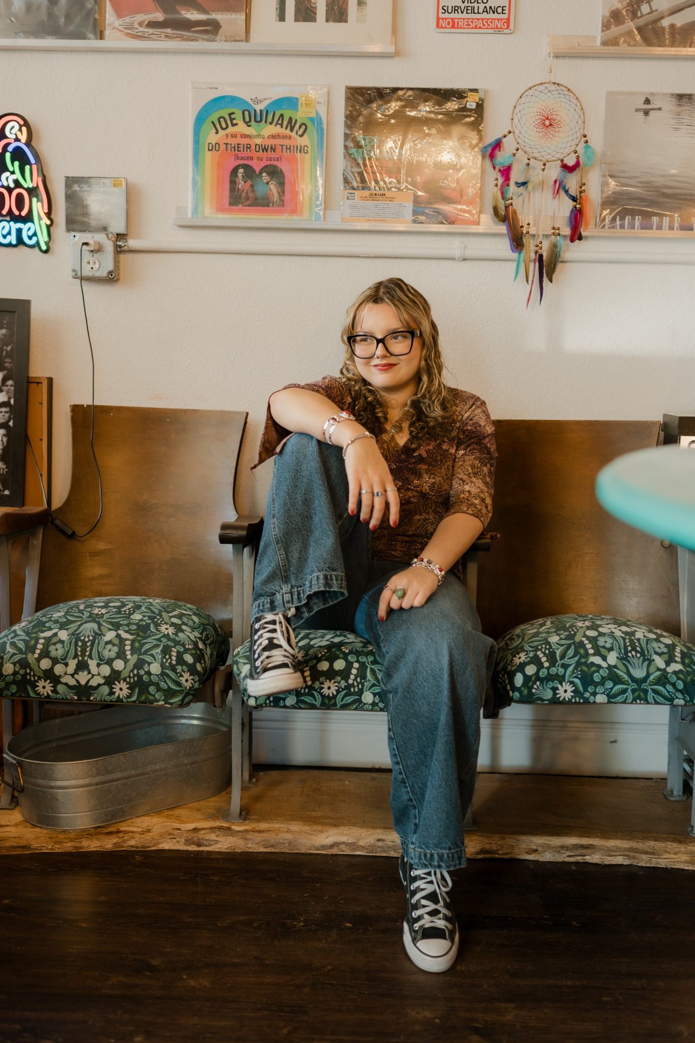 Senior in a patterned top posing among vinyl records near Orlando, Florida