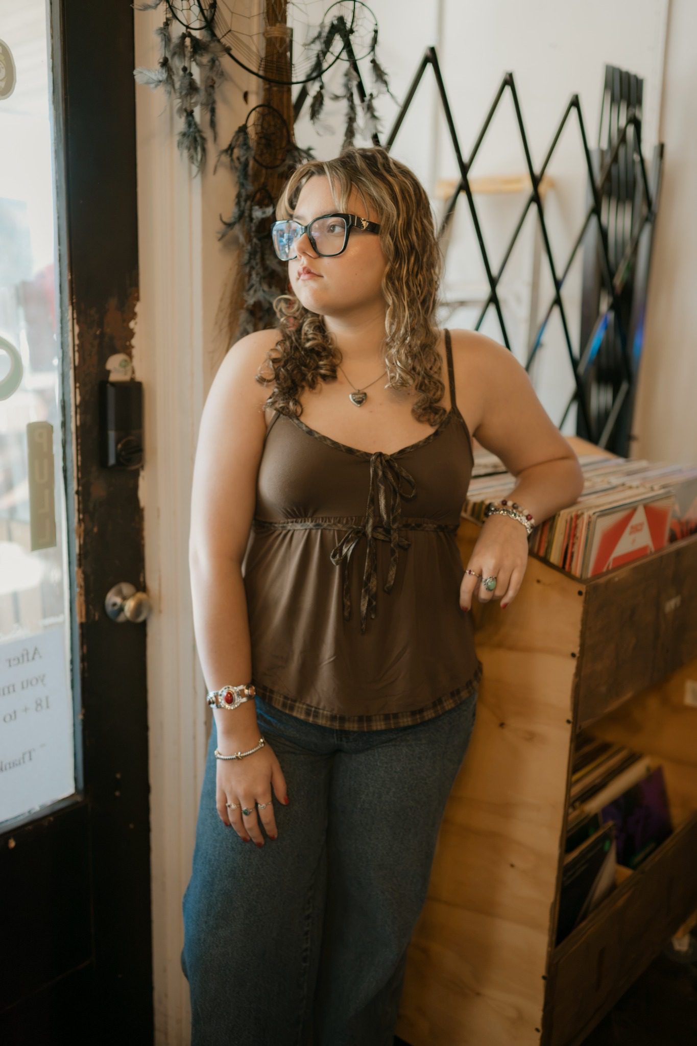 Senior standing between rows of vinyl records in Clermont, Florida