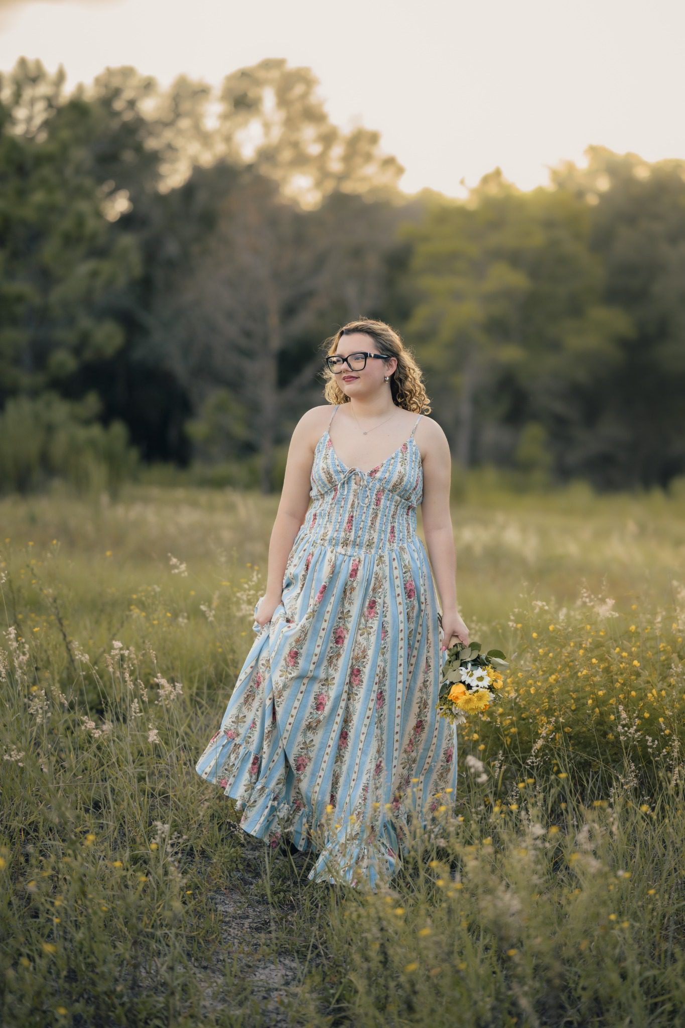 Full-length senior portrait in a floral dress at Lake Louisa near Orlando