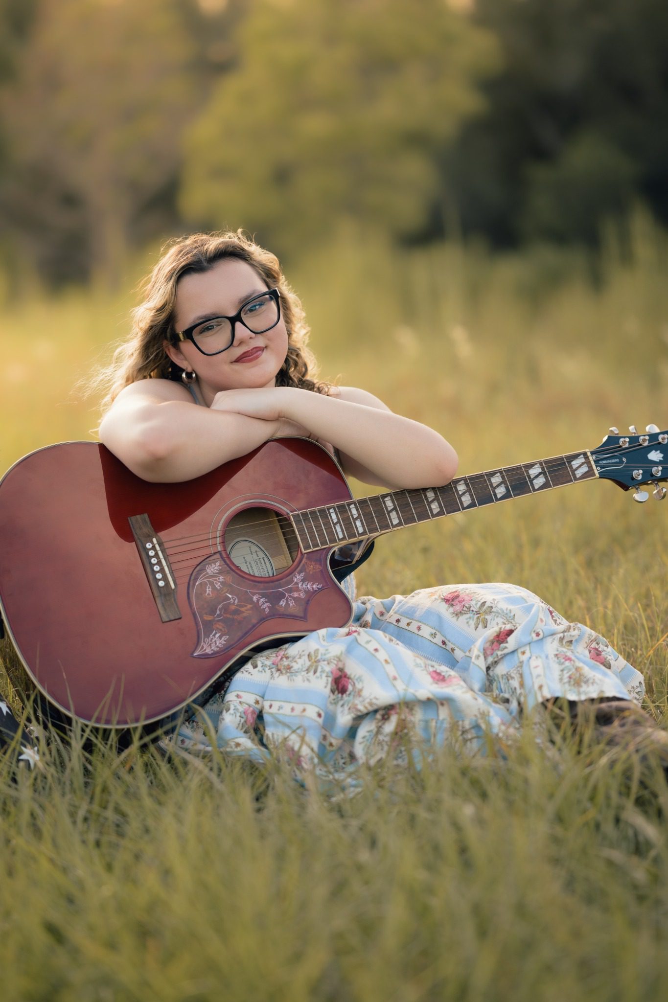 Senior posing with an acoustic guitar at Lake Louisa near Orlando
