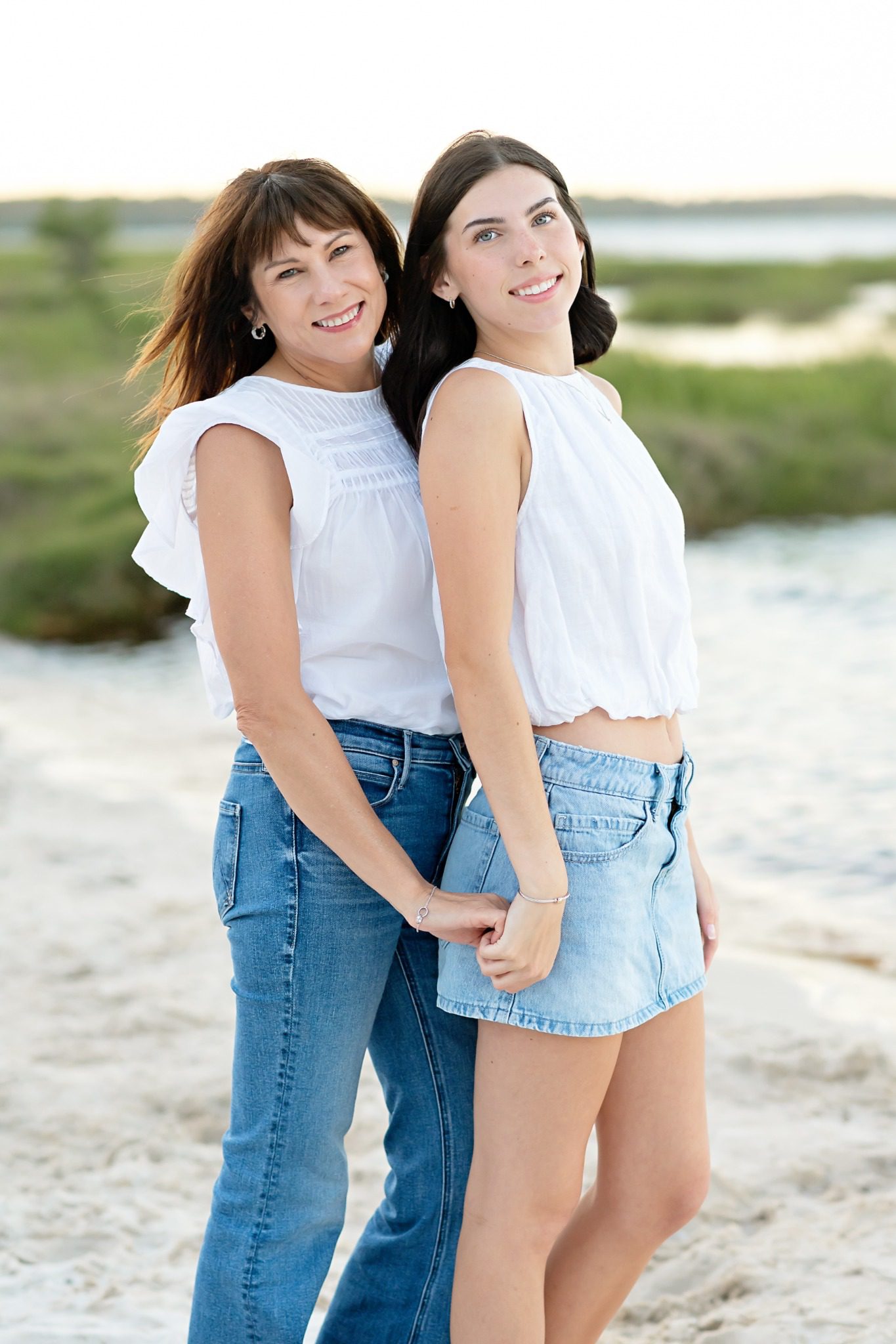 Senior and her mom standing together by Lake Louisa in Clermont