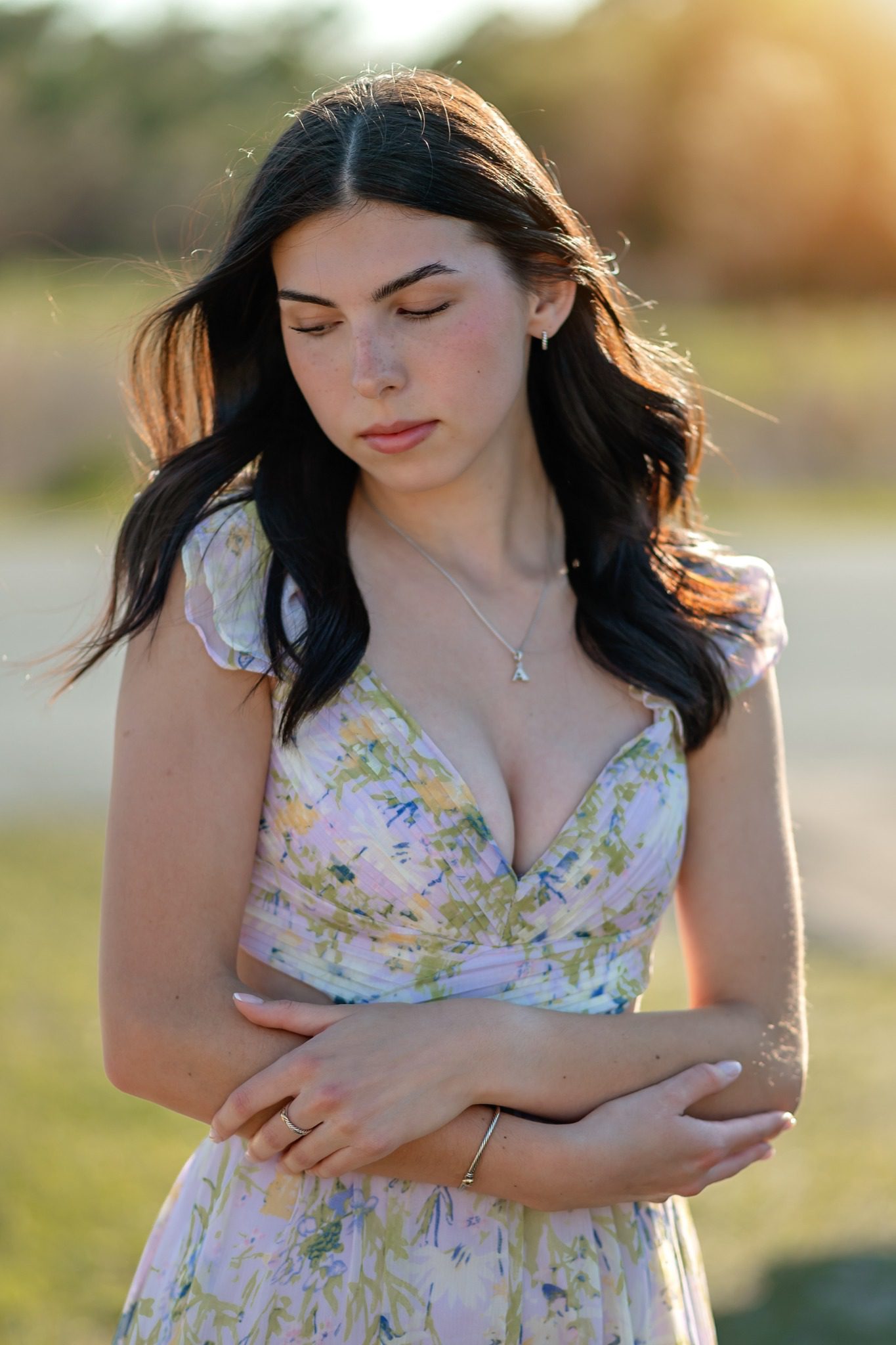 Close-up senior portrait in a floral dress with soft evening light in Clermont